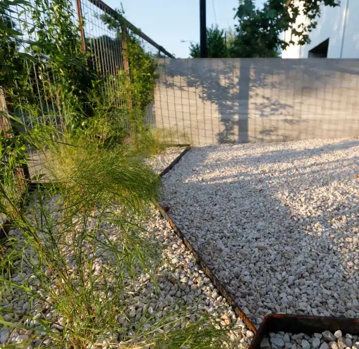 crushed limestone gravel beside lush lawn and plantings