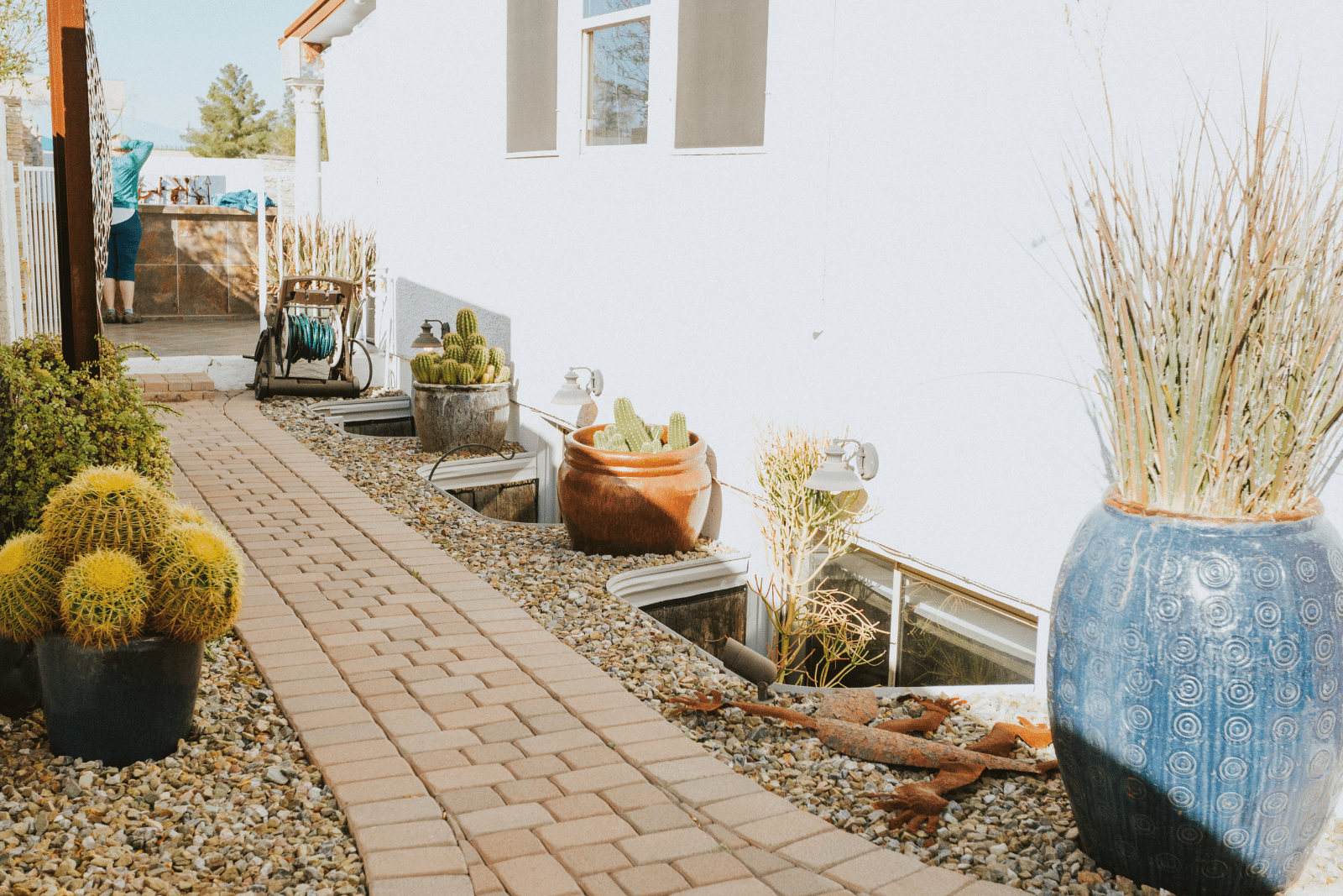 A house featuring professionally designed hardscaping with stone pathways, a patio, and landscaped elements, enhancing the outdoor space.